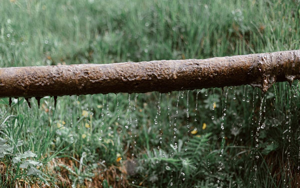 Water pouring from a split section of pipe